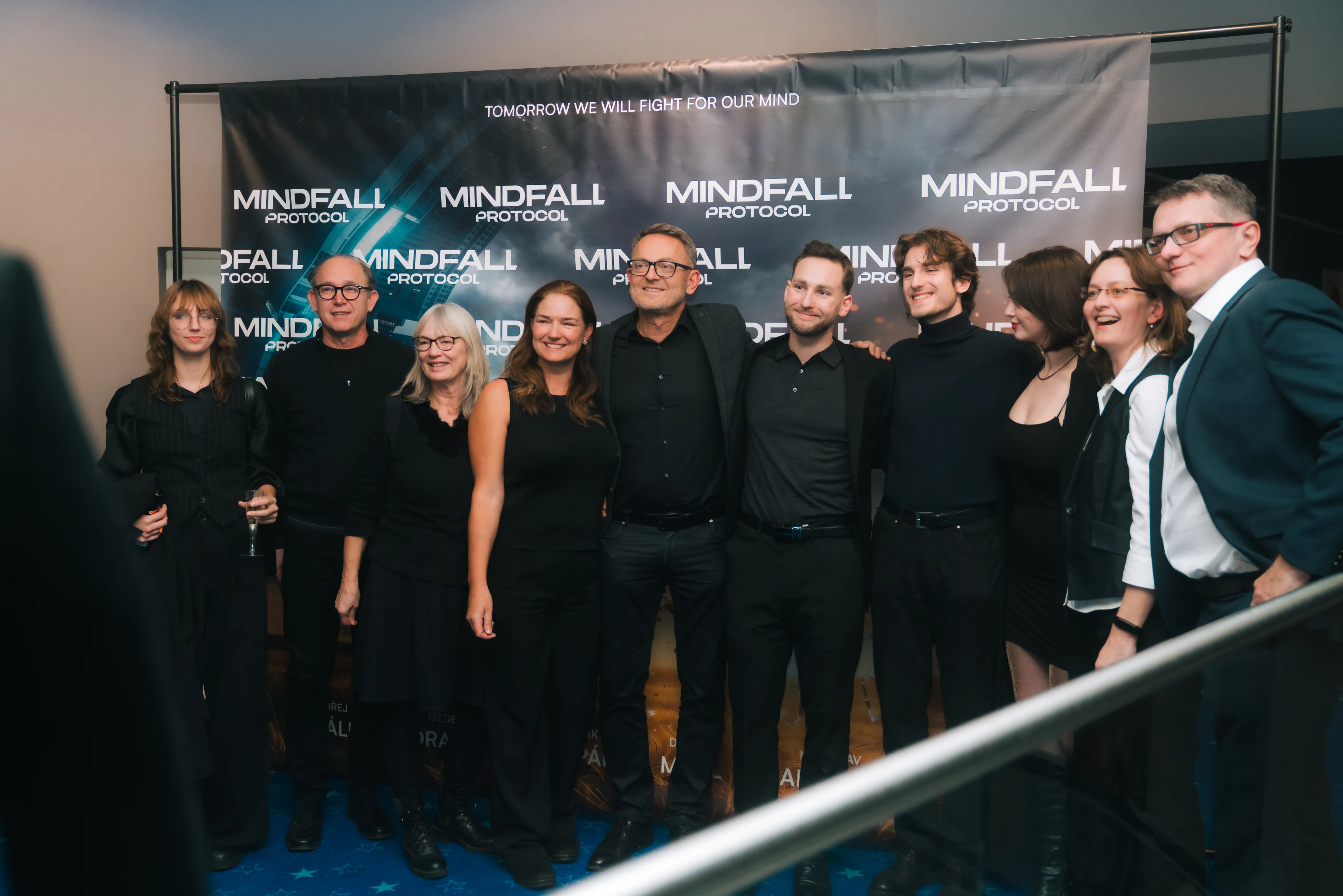 Guests posing in front of Mindfall Protocol backdrop