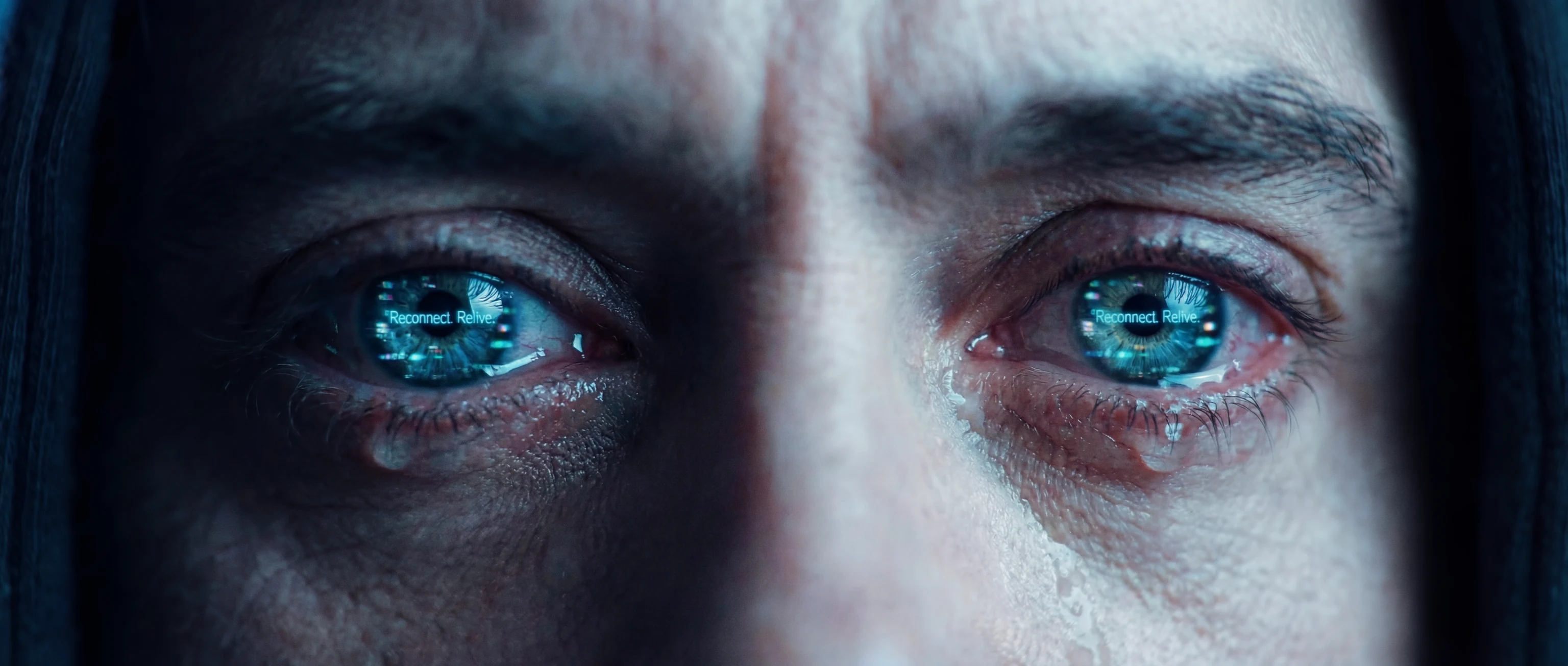 Close-up of Thomas with reflected interface text in his eyes